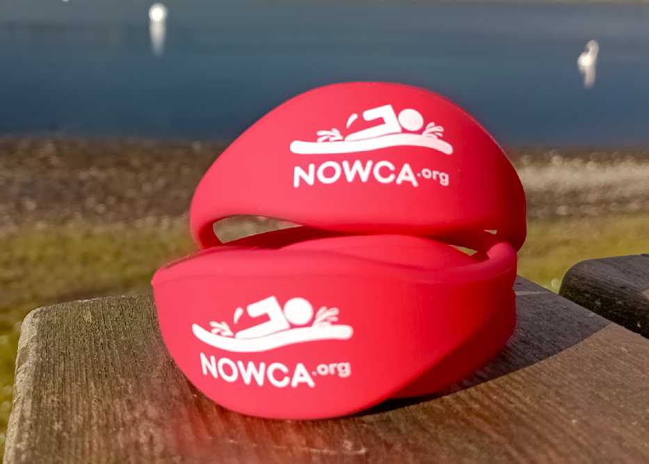 Red NOWCA bands sat on a bench