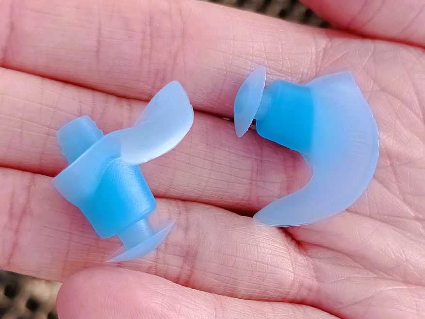 a pair of ear plugs sat on a hand